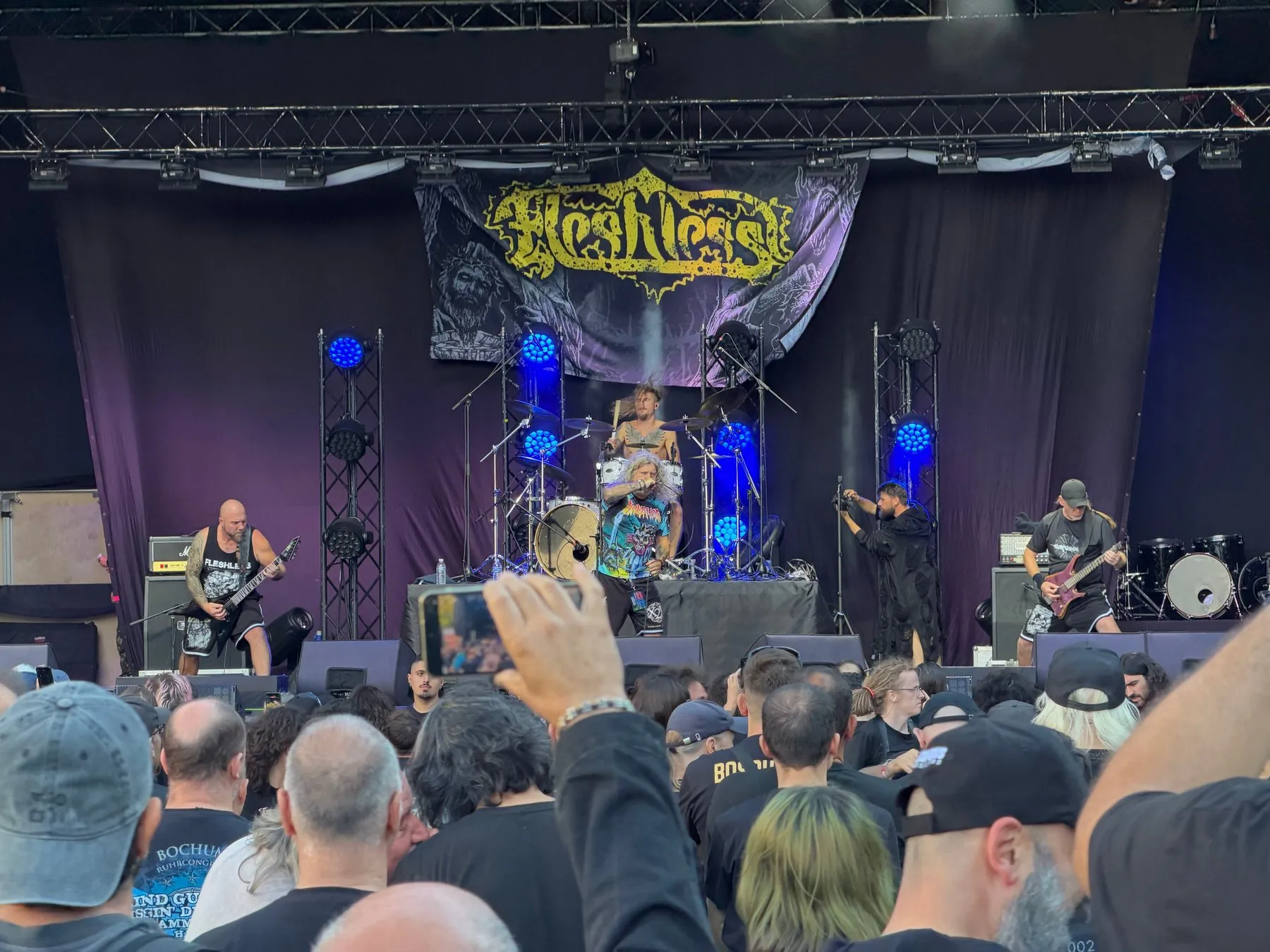 Fleshless performing in front of their banner on the open air stage