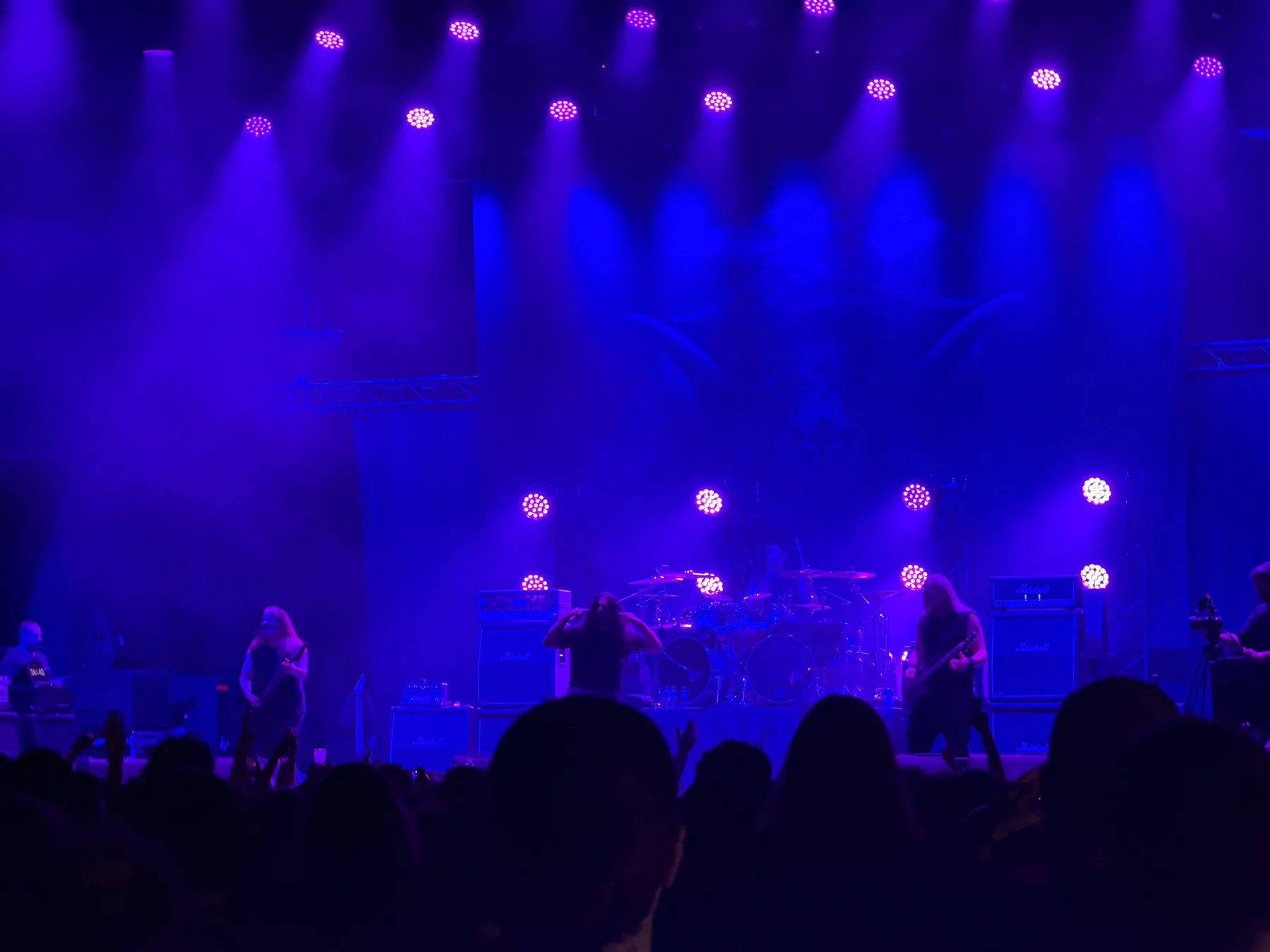 Kataklysm performing beneath blue and purple lights