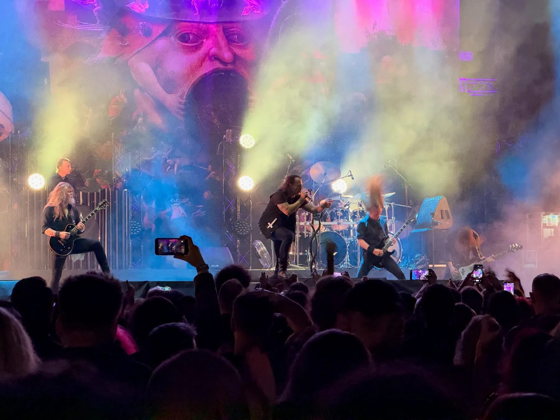 Satyricon performing amid colored lights and smoke