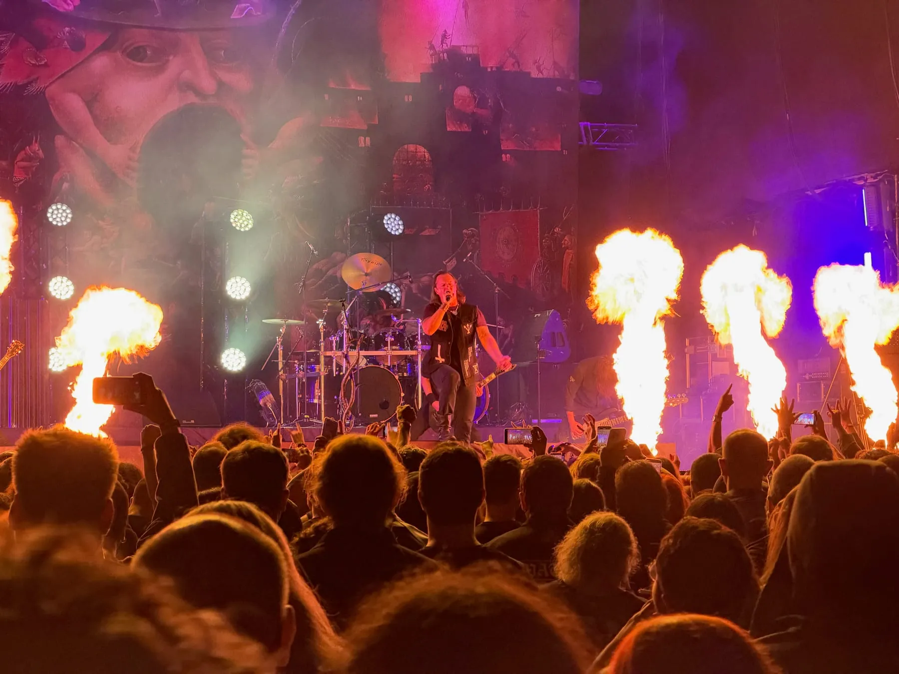 Flames rising beside Satyricon's singer during their set