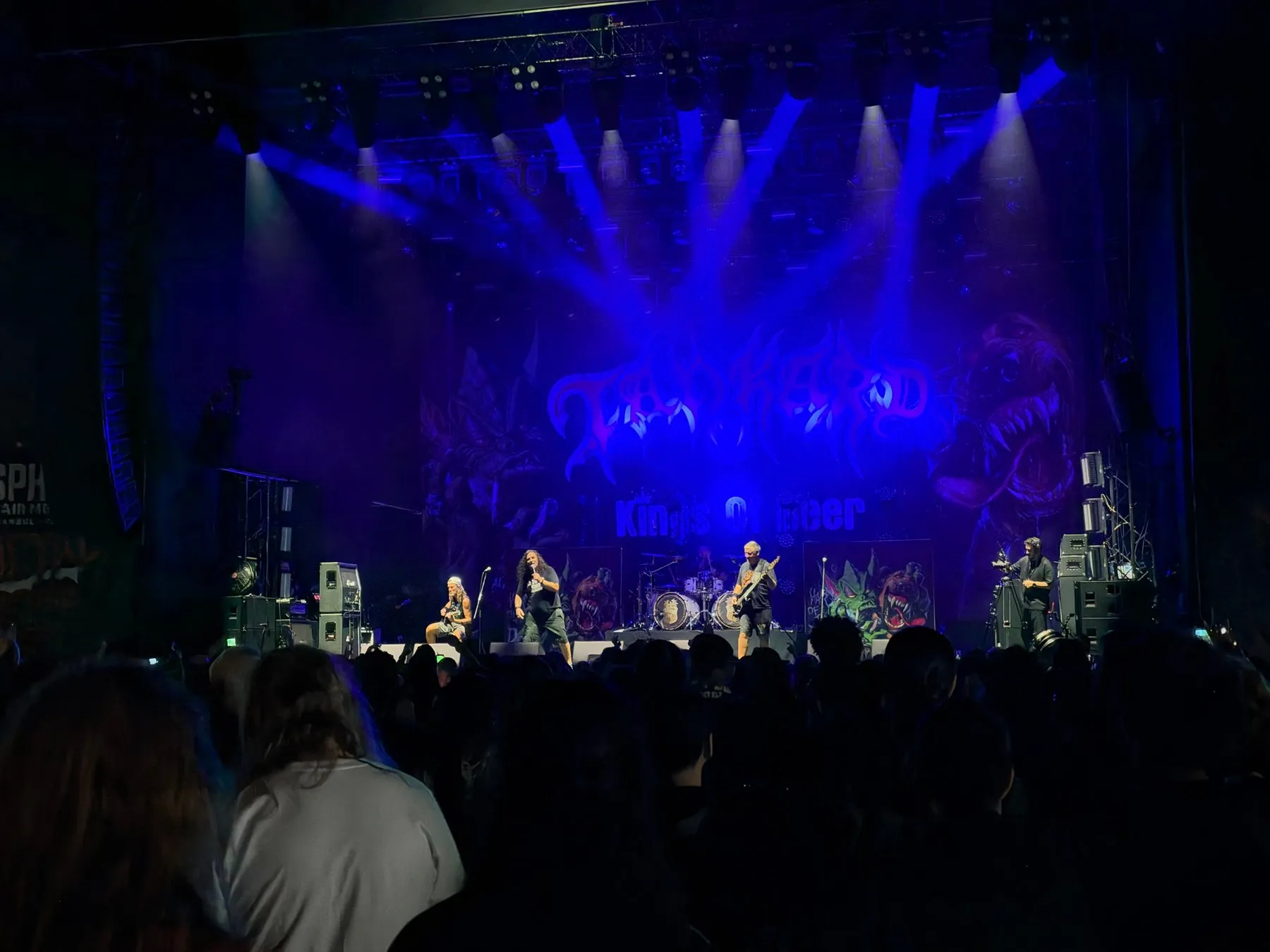 Tankard performing on a blue-lit stage