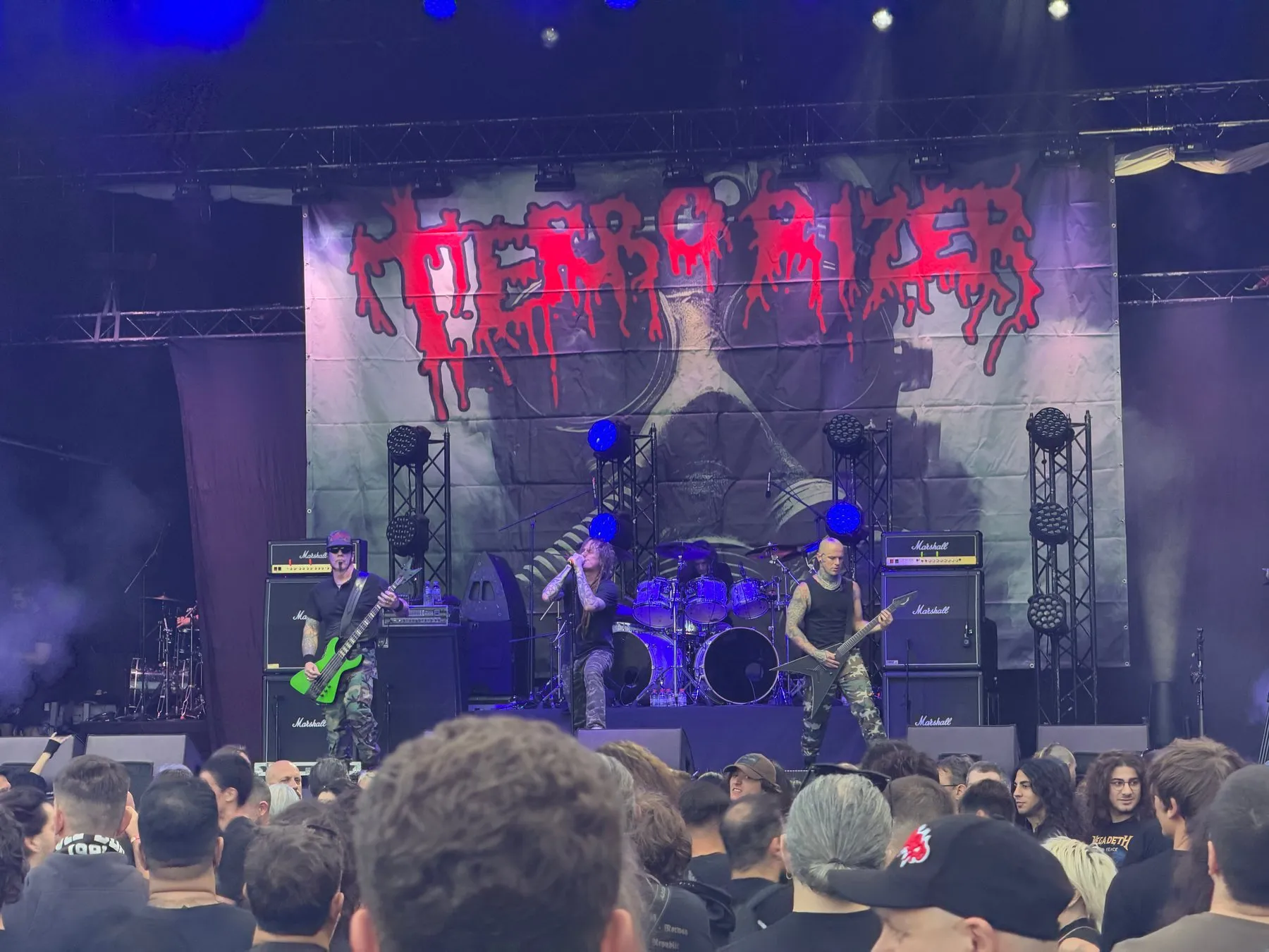 Terrorizer performing in front of their stage banner
